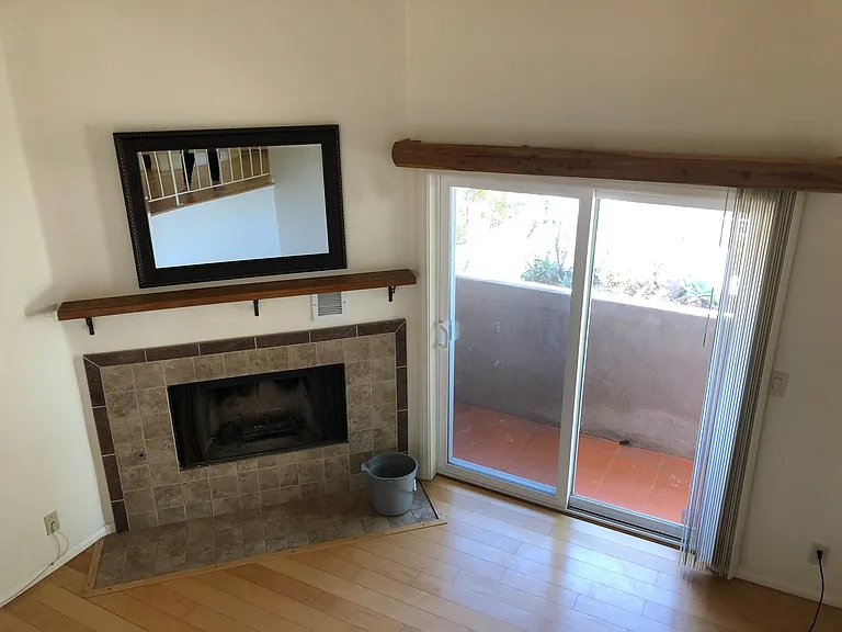 Lower living room with slider to lower balcony. Fireplace is non-usable.