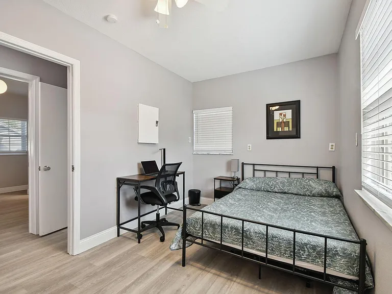 Full size cozy bed, with end table, light and storage container under the bed. Desk, chair & light. Next to bathroom.