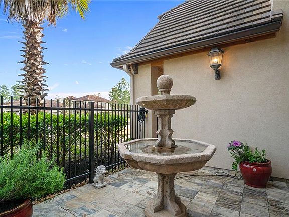 Front patio is super cute with fountain, slate tile and gas light fixtures.