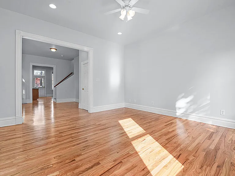 The Living Room, looking towards The Foyer, Stairwell, and The Kitchen, door to The Powder Room in the middle