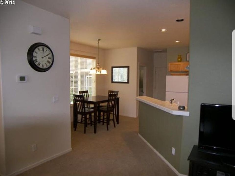 Standing in living room looking ar Kitchen. Half Bathroom in top, the door in top of picture leads to garage