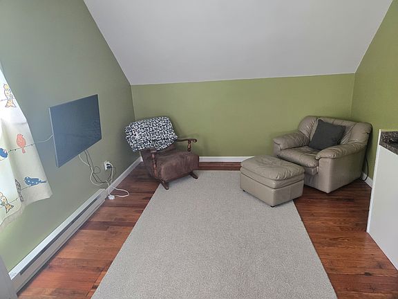 Large open living space with kitchen, living rom and dining area.