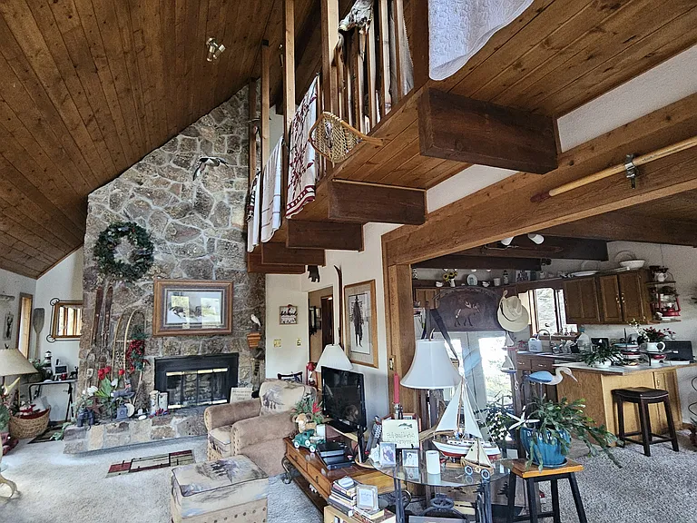 Entrance into second floor of home from deck. Third floor is reached by stairs. 
kitchen is directly to the right and dining room. We often share these areas. behind fireplace