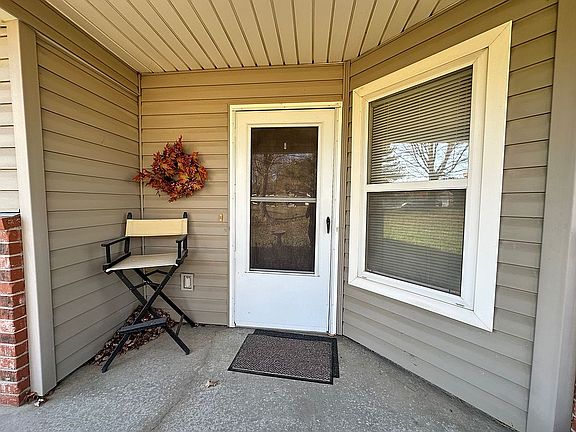 Front door facing treed yard