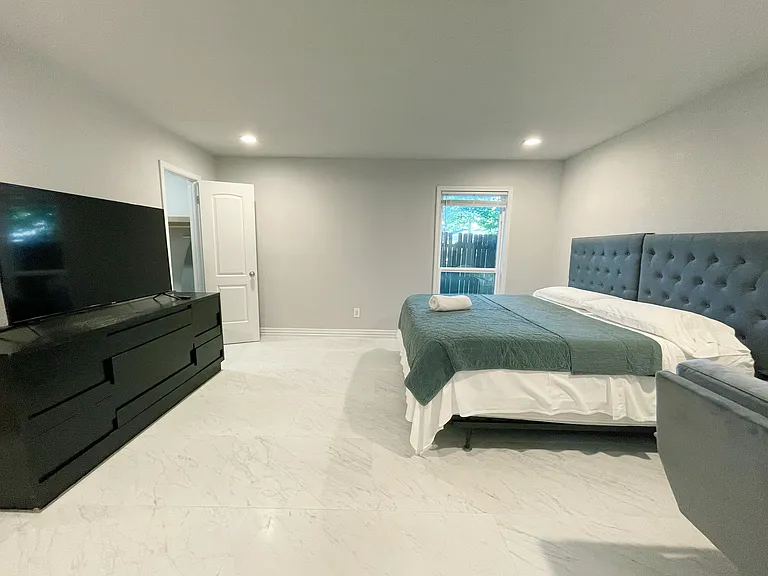 Master Bedroom with California King Bed Size and 55 inch Smart TV