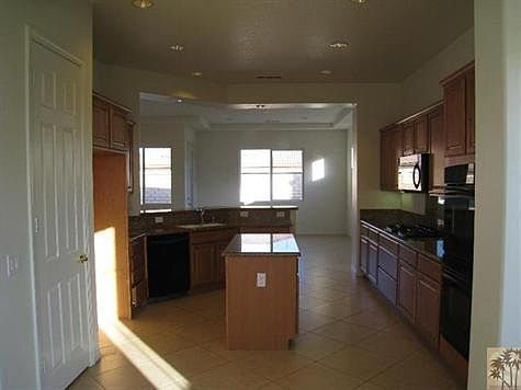 Kitchen with Island, Double sink with garbage disposal, double oven, 5 burner cook top, extraction vent, Dishwasher and a Pantry.