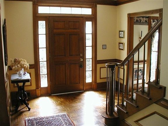 Open Foyer With Hardwood Floor says Welcome