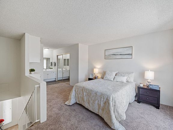 Bedroom and the bathroom in the one bedroom townhome apartment at the Esplanade Apartment in Van Nuys