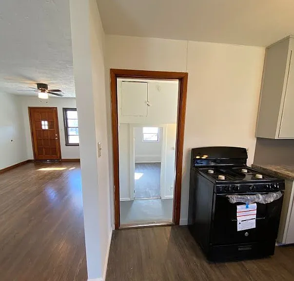 view from kitchen into utility room and first bedroom