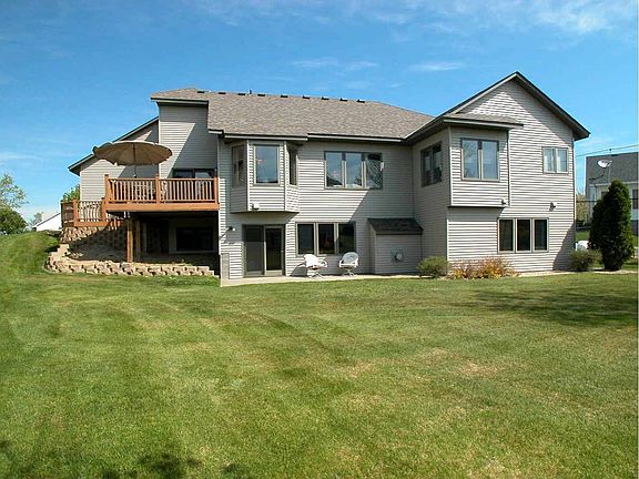 View of the back of home and spacious Backyard.