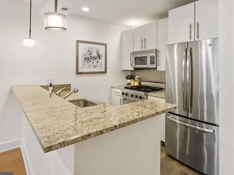 Contemporary kitchen with new stainless appliances - gas stove