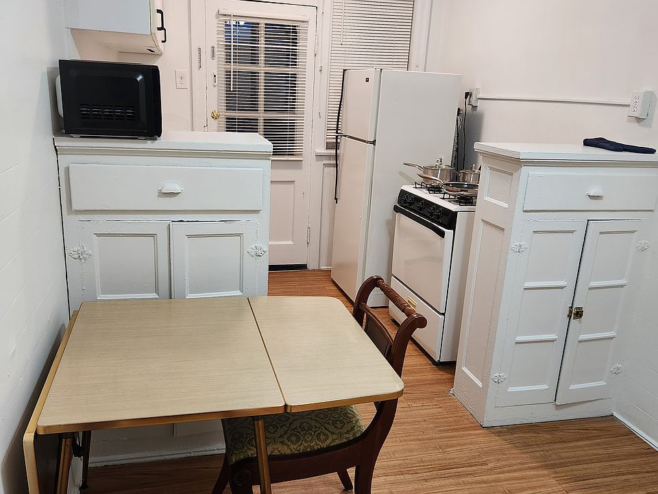 Kitchen with utensils and pot and pans.