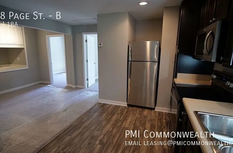 Unit B view from 2nd bedroom looking across living area and kitchen to the other two bedrooms
