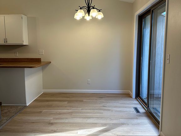 Eat in dining area with bar seating. Sliding glass doors lead to deck