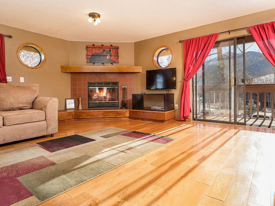 Living Room with wood fireplace and sliding doors to wrap around porch
