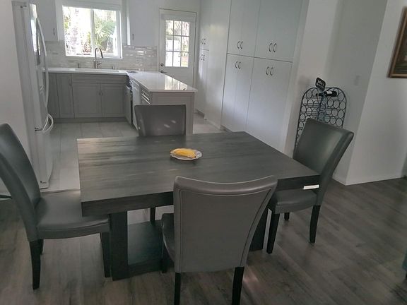From living room, looking at kitchen in back of house.