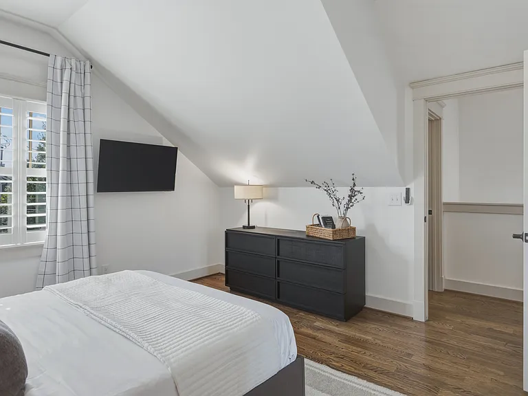 Find a comfortable queen bed in bedroom 3, along with a walk-in closet, dresser, smart TV, and ceiling fan.