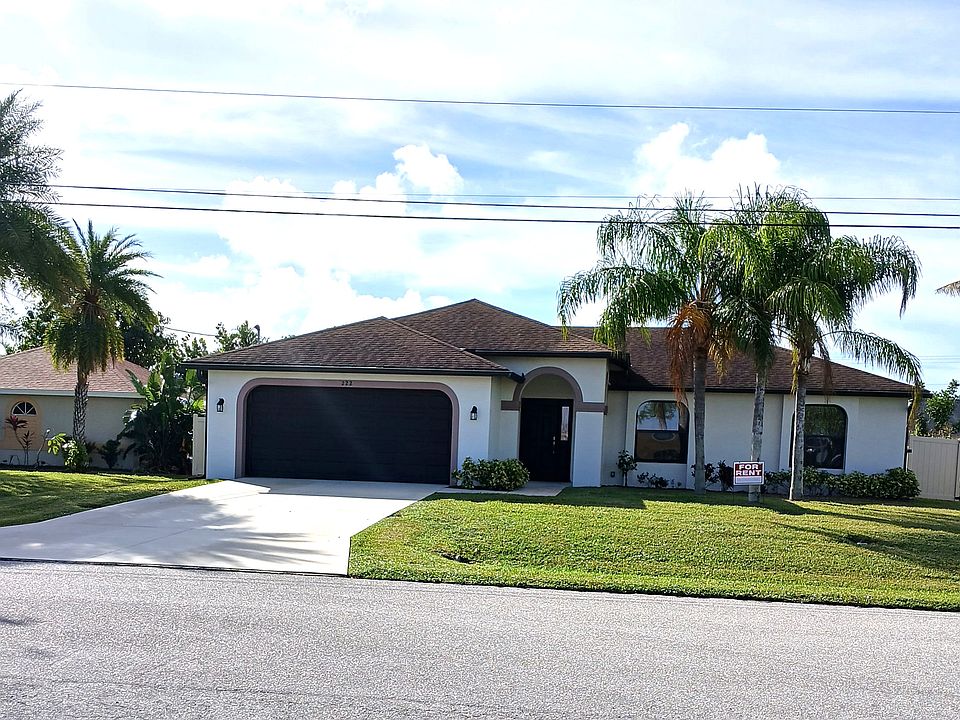 Front of house showing vinyl privacy fence.
