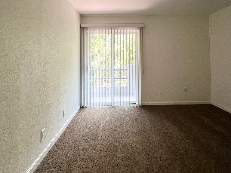 Master Bedroom w/carpet flooring access to the adjoining balcony