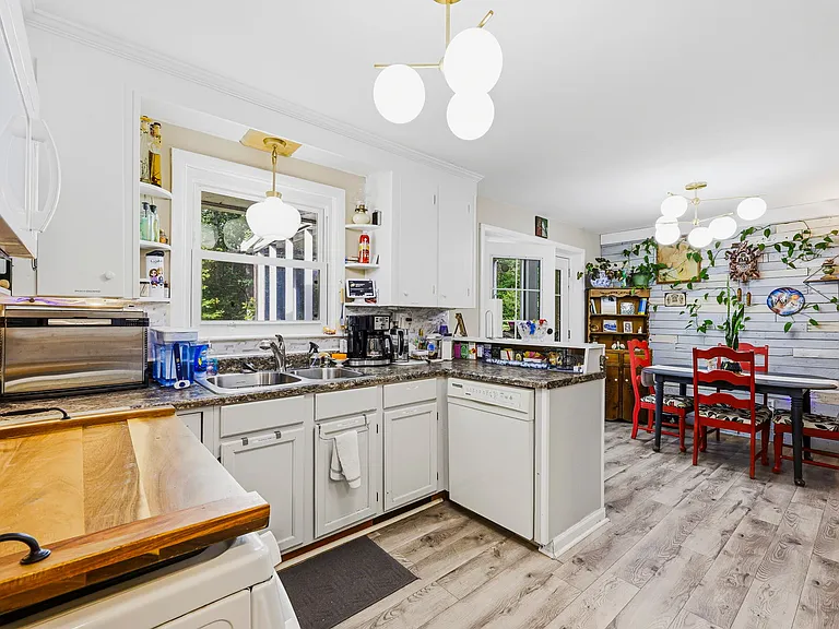 MAIN LEVEL: Kitchen and Dining Room with Double-opening French Doors leading to Back Porch) (Hall, Front Door, and Living Room to right) (UNSHOWN: LAUNDRY AREA, 1/2 BATH, AND GREAT ROOM BEHIND CAMERA)