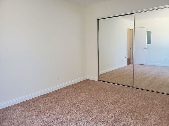 Spacious bedroom featuring new carpeting