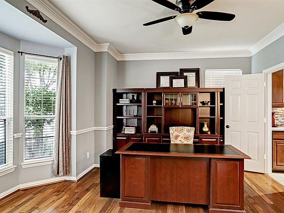Just off the entry with access to the kitchen lies the formal dining. Currently being used as a office, this room offers front yard views, crown molding, vinyl plank wood flooring and lighted ceiling fan.