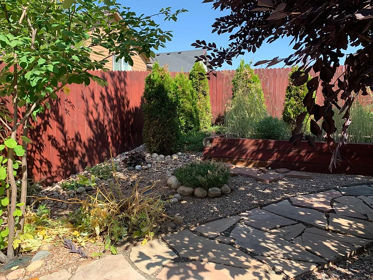 backyard with privacy fence and raised garden.
