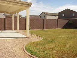 Large cover patio opens up to professionally landscaped, auto irrigation lawn