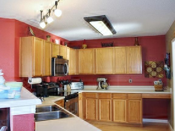 Kitchen with laminate floor covering, updated lighting and kitchen appliances are included