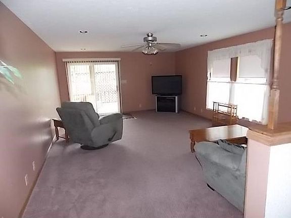 Family Room. View of 21x15 family room with ceiling fan, recessed lights and sliding glass door.