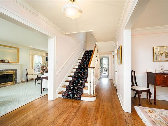 The gracious foyer welcomes you to the home, and includes a powder room and huge walk-in closet with