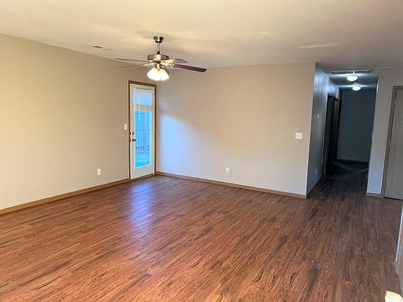 LR FROM FRONT DOOR. DOOR IN PHOTO OPENS TO ENCLOSED PATIO