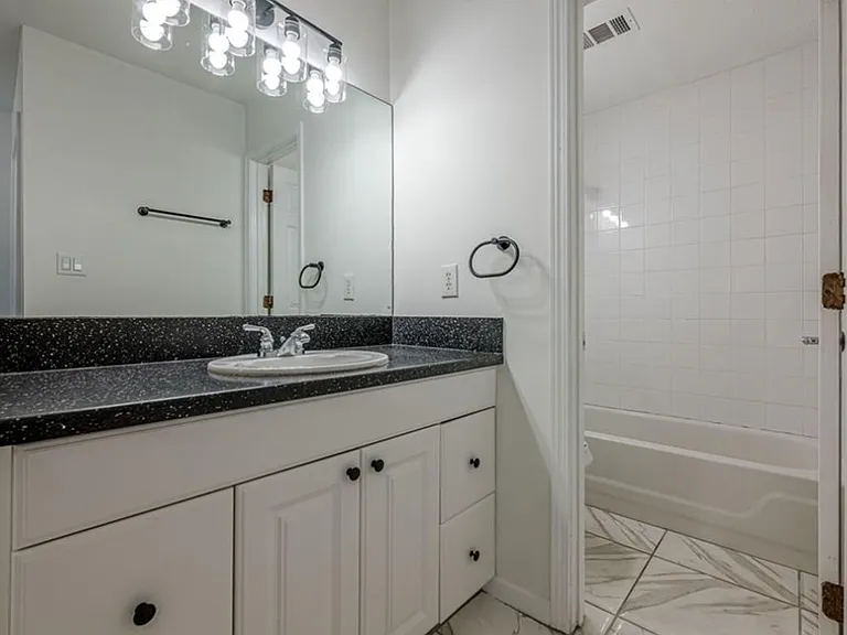 Full First Bathroo featuring vanity and shower / washtub combination