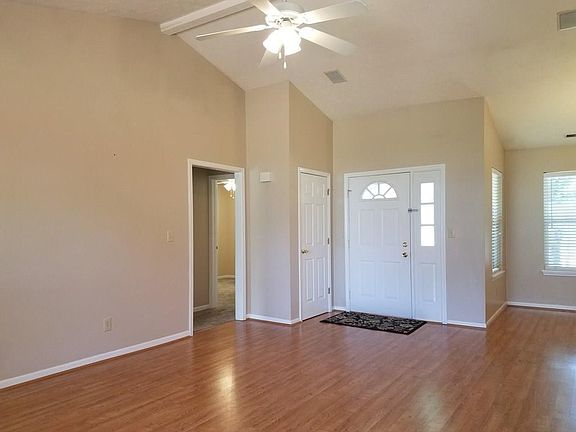Great Room- Vaulted ceilings, open and airy! Gleaming laminate flooring throughout.