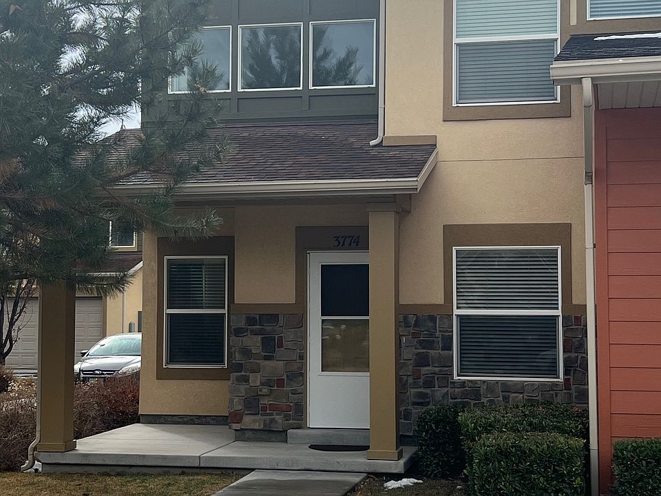 Front of townhouse with enough room for a BBQ and a nice grassy area for a dog.
