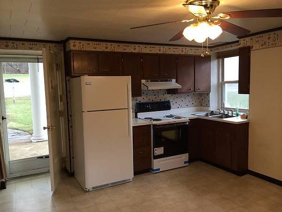 Large, country kitchen with newer fridge and stove