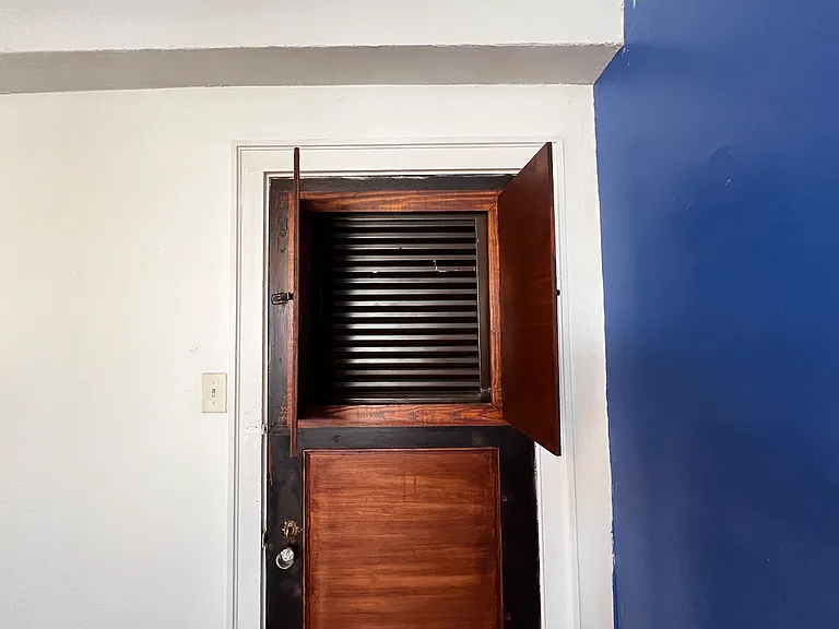 The unit's front door allows the option to open for ventilation from the exterior hallway.