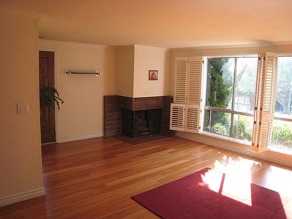fireplace,living room with new plantation shutters and hardwood floors