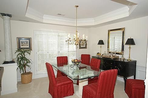 Formal dining room with columns and trey ceiling