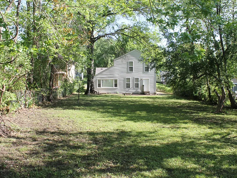 Large fenced backyard with patio