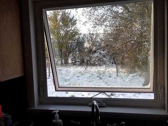 New insulated window in kitchen opens at bottom to keep weather out.