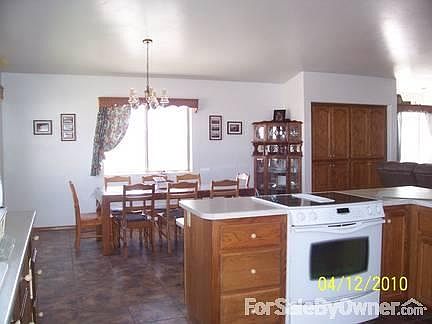 Kitchen/Dining Room
						:
						Kitchen, dining, and living room all open with vaulted ceiling.