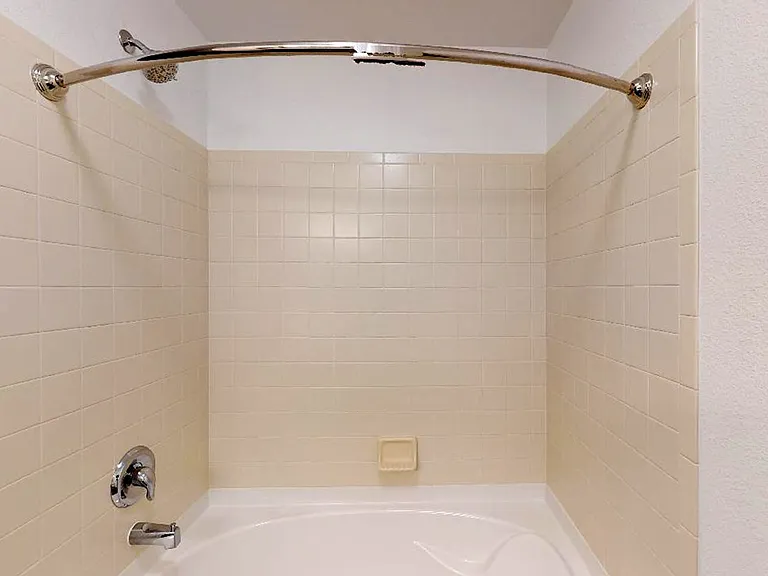 Apartment bathroom with tile flooring.