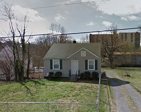 big fenced front yard, off-street parking in back.