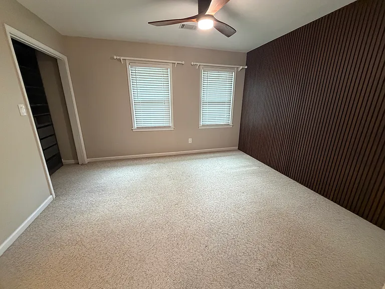 Front bedroom with a full bathroom and closet with built-ins.