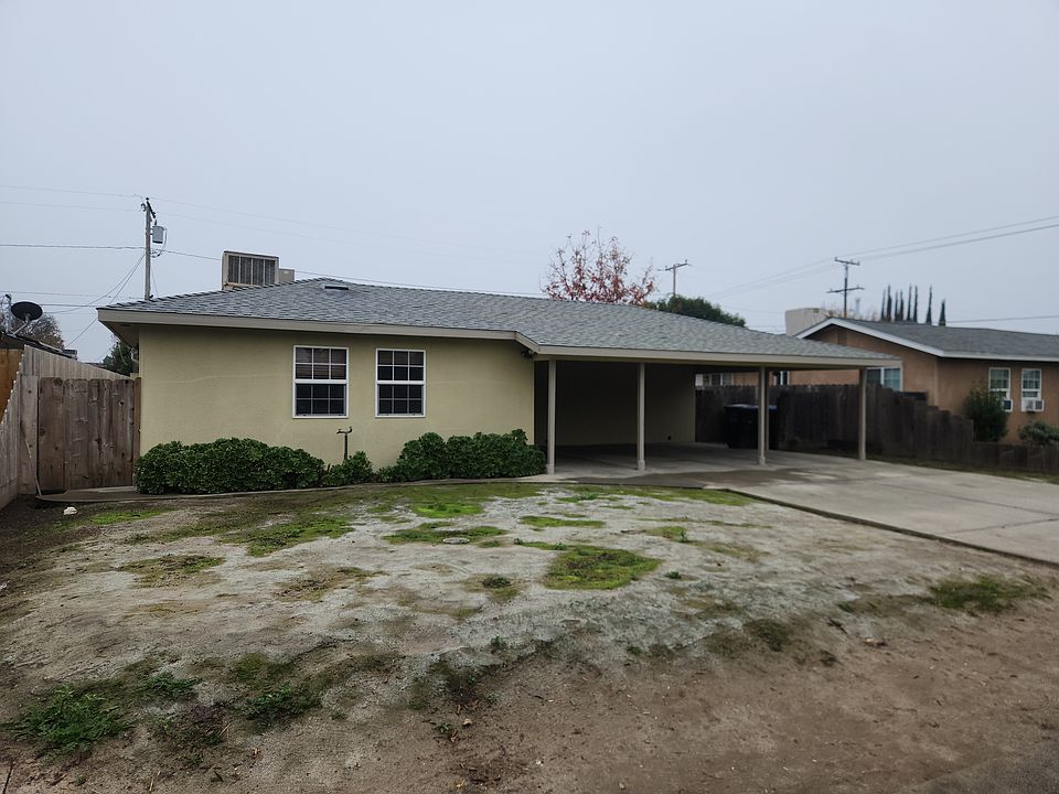 Front view with 1 carport for each unit