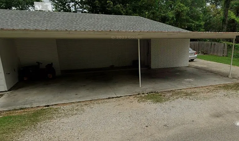 Front door entry to the apartment is under the carport.