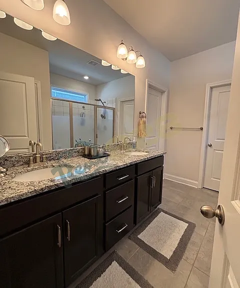 Primary bathroom with dual vanity and upgraded, extra-large walk-in shower