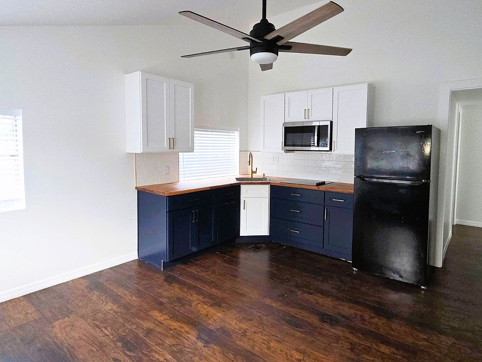 Bright studio with a spacious kitchen, ample cabinets, microwave, fridge & ceiling fan.