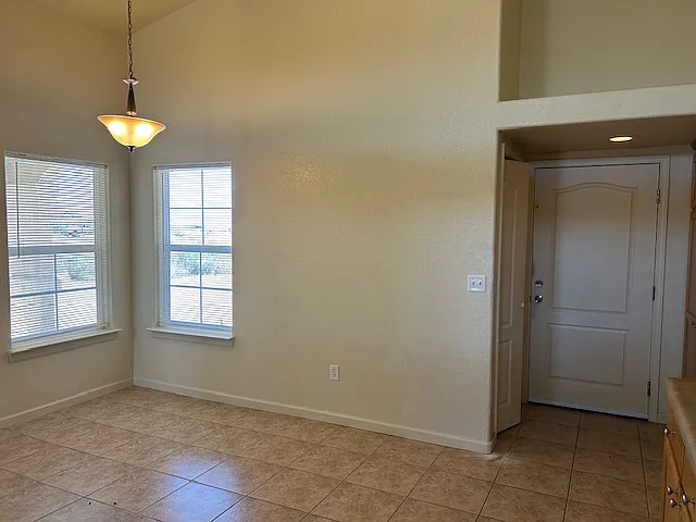 Dining area with view to laundry room and garage door.